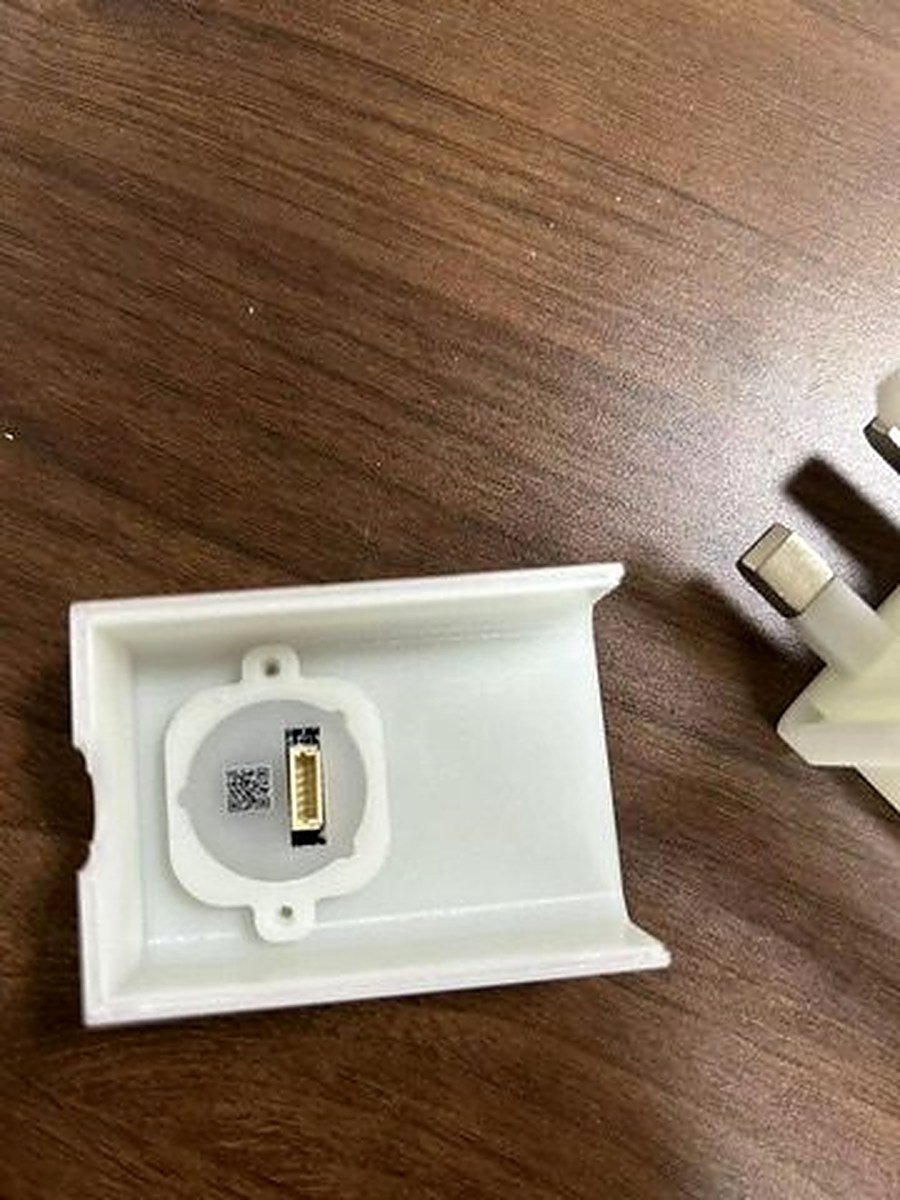 Charlie Charger fingerprint sensor module with gold connector pins, mounted in white 3D-printed housing