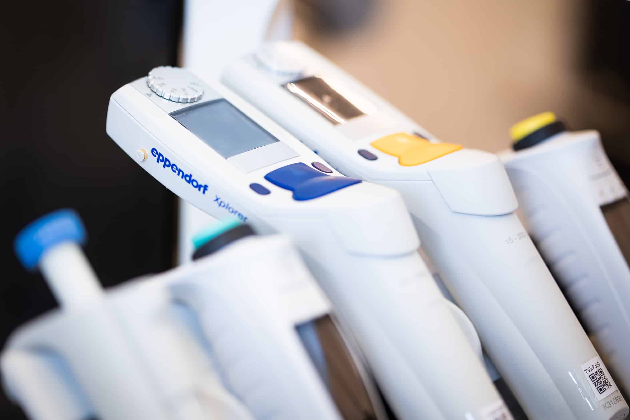 Eppendorf Xplorer pipettes in a laboratory rack — the instruments Calvolver was designed to calibrate automatically